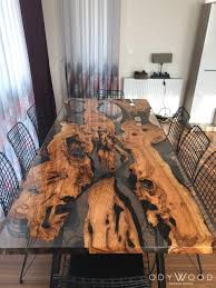 Knots, cracks and holes are inherent characteristics in many of our one of a kind wood pieces, they create the character of the piece. Live Edge Olive Slabs Dining Table With Transparent Epoxy Custom Odywood