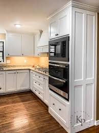 The pleasing blend of traditional cabinetry with modern warm gray paint creates a casual, comfortable kitchen atmosphere. Kitchen Cabinets In Sherwin Williams Dover White Painted By Kayla Payne