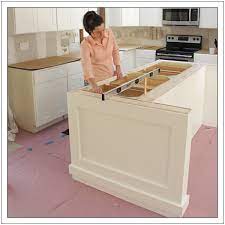Essentially, the base is a wood frame, attached to the floor using l brackets, that the cabinets sit on top of. Build A Diy Kitchen Island Build Basic Building A Kitchen Build Kitchen Island Kitchen Design Diy