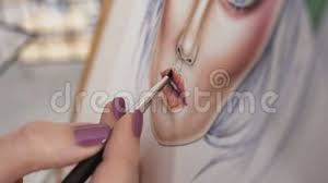 close up view of an artist s hand using special brush for drawing lips with lipstick professional makeup artist