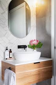 Check Out The Double Herringbone Tile Pattern And That Gorgeous Oval Mirror Love The Wall Hung Bathroom Lighting Design Wall Hung Vanity Bathroom Tall Cabinet