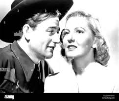 A LADY TAKES A CHANCE, l-r: John Wayne, Jean Arthur, 1943 Stock Photo