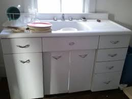 Old metal kitchen sink cabinets. A Beautiful Built In Bed Is Quite Glamorous With Its Mirrored Cabinets Headboard And Vintage Looking Li Vintage Kitchen Sink Sink Cabinet Kitchen Sink Cabinet