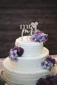 Browse through our exquisite flowers and cakes combo to send your dear ones as a token of love.</p> Two Tier White Wedding Cake With Purple Flowers