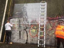 The mural has now been covered in brown paper. Hull Window Cleaner Saves Defaced Banksy Mural Bbc News