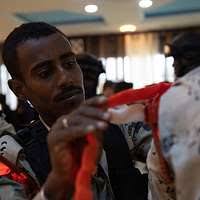 Local Iraqi residents watch a ribbon cutting ceremony