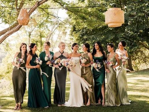 large bridal party with different colored bridesmaid dresses