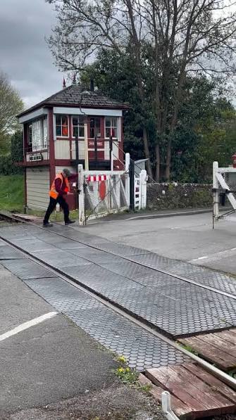 The traditional way of operating a railway level crossing in Great Britain. , The crossing gates are closed and secured before the signal is given for the train to proceed. , This is a heritage ...