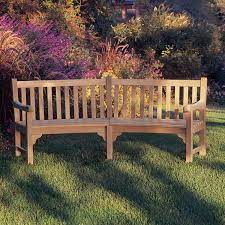 Park bench near a huge tree. Canora Grey Dunloy Curved Wooden Garden Bench Reviews Wayfair
