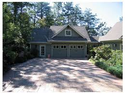 Here, a classic structure feels in step with the collection of outdoor hardscape and landscape elements, including an outdoor paved living space and a wide planting bed. Plan 053h 0001 The House Plan Shop