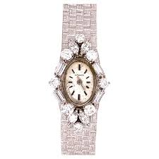 Defined by a single dot at 12 o'clock, symbolizing the sun . Ladies White Gold Movado 2 Carat Natural Colorless Diamond Manual Cocktail Watch For Sale At 1stdibs