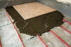 Press it firmly to the concrete, using the palms of your hands and all your weight. Ceramic Tiles And Tools For Tiler Floor Tiles Installation Home Improvement Renovation Ceramic Tile Floor Adhesive Stock Photo Picture And Royalty Free Image Image 93465334