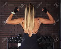 And you should take up a little weight training to strengthen your muscles or perhaps try cycling to build up your cardiovascular system. Fitness Woman Showing The Biceps And Back Muscles Against Brick Stock Photo Picture And Royalty Free Image Image 87913231
