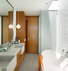 They combine with vertical and horizontal wall sconces to offer plenty of light. Lowes Bathrooms Vanity With Window In Shower And Globe Pendant Light