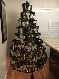 Once the lights are fully inserted (as shown in the photo) it is worth sealing them in with a thick piece of tape. Complete With The Room Lights On Wine Bottle Christmas Tree Diy Christmas Tree Stand Christmas Tree Stand