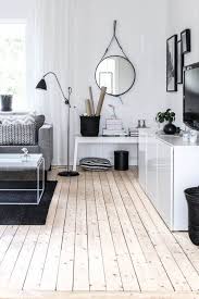 Medium sized scandinavian master bedroom in gothenburg with white walls, painted wood flooring and no fireplace. Creating Cosiness In An All White Room