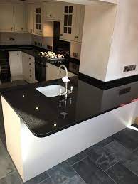 This stunning white and grey kitchen features white cabinets grey granite countertops and a simple 3 pendant lighting fixture in pewter to match the hardware and appliances designer. Pin On Kitchen