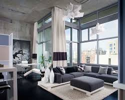 Chic living room boasts an industrial metal and glass sliding door on rails positioned behind a black comfy sofa paired with a gold accent table and positioned on a gray rug facing a round black coffee table. 55 Incredible Masculine Living Room Design Ideas Inspirations
