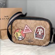 .(coach f79948) qb/black multi smooth calf leather and signature coated canvas zip closure, fabric lining outside zip pocket adjustable strap for wear at waist 11 1/2 (l) x 5 1/2 (h) x 2 3/4 (w) ™ lucasfilm ltd. Coach Bags Coach X Star Wars Jes Crossbody Bag Poshmark