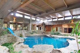 This swimming pool is enclosed to maintain the neatness and cleanliness of the surroundings. 20 Homes With Beautiful Indoor Swimming Pool Designs Indoor Swimming Pool Design Indoor Outdoor Pool Amazing Swimming Pools