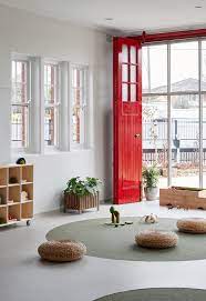 At Villa Bambini In Essendon Victoria Australia The Red Door Is Wide Open So Children Can Turn Toward The Future White Home Decor White Rooms White Houses
