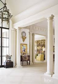 Limestone Columns And Moldings Give Visual Heft To The Home S Open Plan Galleries And Public Spaces Where Much Of The Wife S Art Co Luxe Interiors Home Design