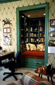 A dark sleek and tall bookcase and a table with a. 50 Most Jaw Dropping Home Library Design Ideas