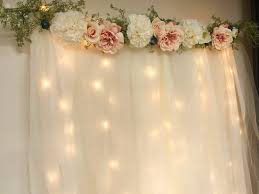 To make these backdrop garland lines you will use a needle on a string to feed marshmallows through the entire length. Diy Lit Tulle Backdrop Six Clever Sisters