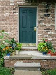 This turquoise door pairs well with simple front porch decor. Vintage Sweet Peas Welcome Fall Teal Front Doors Green Front Doors Best Front Door Colors