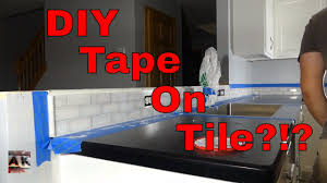 Remove the protective film from one side and stick the mat to the wall, pressing and smoothing the surface to achieve a good bond. Diy Tile As Easy As Double Faced Tape Youtube