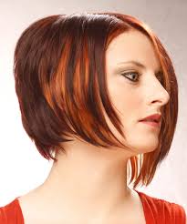 The back and sides of this short and sophisticated 'do are tapered into the head blending into the top layers that are swept to the side for shape and style. Short Straight Dark Mahogany Red Asymmetrical Hairstyle With Orange Highlights