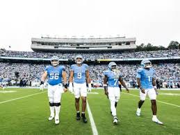 North Carolina football players celebrating a win over Pitt at Acrisure Stadium
