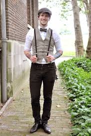 Beige Tweed Vest Worn Over A White Shirt With Rolled Up Sleeves And A Bowtie By A Smiling Man In Bla In 2020 1920s Mens Fashion Suspenders Men Fashion Party Outfit Men