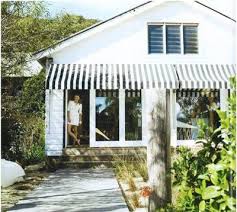 Black And White Striped Retractable Awning Driftwood Interiors Stripe Me Lucky Beach House Exterior House Awnings House Exterior