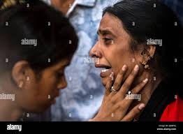 New Delhi, India. 14th May, 2022. Mother of a fire victim (R) wails when  waiting for the body of her daughter at a hospital in New Delhi, India, May  14, 2022. At