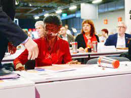 This is the moment a german mp was slapped in the face with a chocolate cake during a party conference in an apparent protest over her views on refugees. German Opposition Leader Attacked With Cake Over Migrants Times Of India