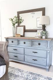 Nightstands and dressers provide ample surface space for glasses, books and cellphones along with drawers for additional storage. Blue Cottage Style Guest Bedroom Makeover Reveal Guest Bedroom Makeover Bedroom Makeover Home Decor