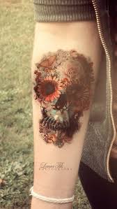 This tattoo shows a conspicuous image of an old clock which appears to be on fire with some parts burnt off. 50 Eye Catching Wrist Tattoo Ideas Art And Design Tattoos Skull Tattoo Flowers Tattoos For Guys
