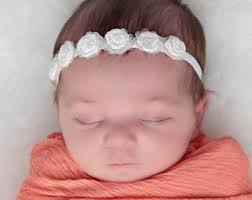 Newborn Headband With Irridescent Sequins Surrounding White Satin Roses