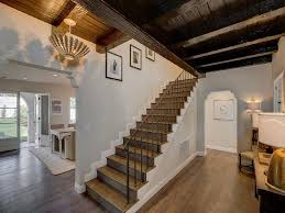 This kitchen features tiles walls and hardwood flooring, along with a ceiling with beams. Glossy Black Ceiling Beams Design Ideas