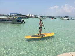 Crab island is actually not an island, but a shallow area of water that is as little as waist deep in some parts. Small Groups Can Get To Crab Island On Paddleboard If You Are Prepared For A Workout Destin Island Water Park Boat Rental