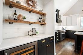 The black countertops add drama to the design while white cabinets, white shiplap walls and open shelving keep the space feeling bright. The Best Farmhouse White Paint Interior Exterior Colors