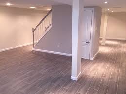 Loving My Basement Modern Clean Shades Of Grey Grey Wood Tile Sherwin Williams Paint In Popula Basement Remodeling Basement Makeover Basement Renovations