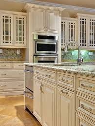 This kitchen used sage green as the main color cabinet and mixed in white cabinets for the island. Cabinet Color Maple Amaretto Cream Glaze Kitchen Remodel Kitchen Soffit Kitchen Cabinets Makeover