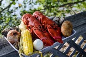 Once you remove your chicken, add the corn and seafood boil on top. Cabbage Island Clambakes