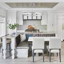 Blue kitchen featuring a large center island with a thick marble countertop and has space for a breakfast bar with gorgeous bar stools. L Shaped Kitchen Design Ideas