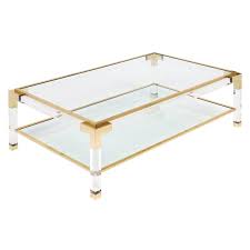 Large coffee table with two glass shelves in the style of charles hollis or maison jansen, the windows are removable and the frame is made of lucite with corners in polished brass. French Lucite And Brass Coffee Table At 1stdibs
