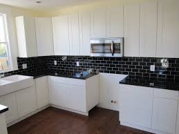 Black And White Ceramic Tile Backsplash White Kitchen Cabinets With Black Countertop Black Countertop Cabinets Furn Wooden Kitchen Cabinets Kitchen Remodel Design Kitchen Cabinets And Countertops