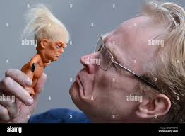 Gallery owner Frank O'Dea with a vinyl doll which features President Donald  Trump, made by a former sculptor for Disney, Chuck Williams. Donald Trump  Troll dolls can be seen and bought at