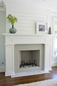 A blue bench sits on a blue jute rug at the foot of the bed warmed by a double sided beveled fireplace framed by a shiplap wall. A Custom Diy Fireplace Mantel Beneath Our Shiplap Old Town Home